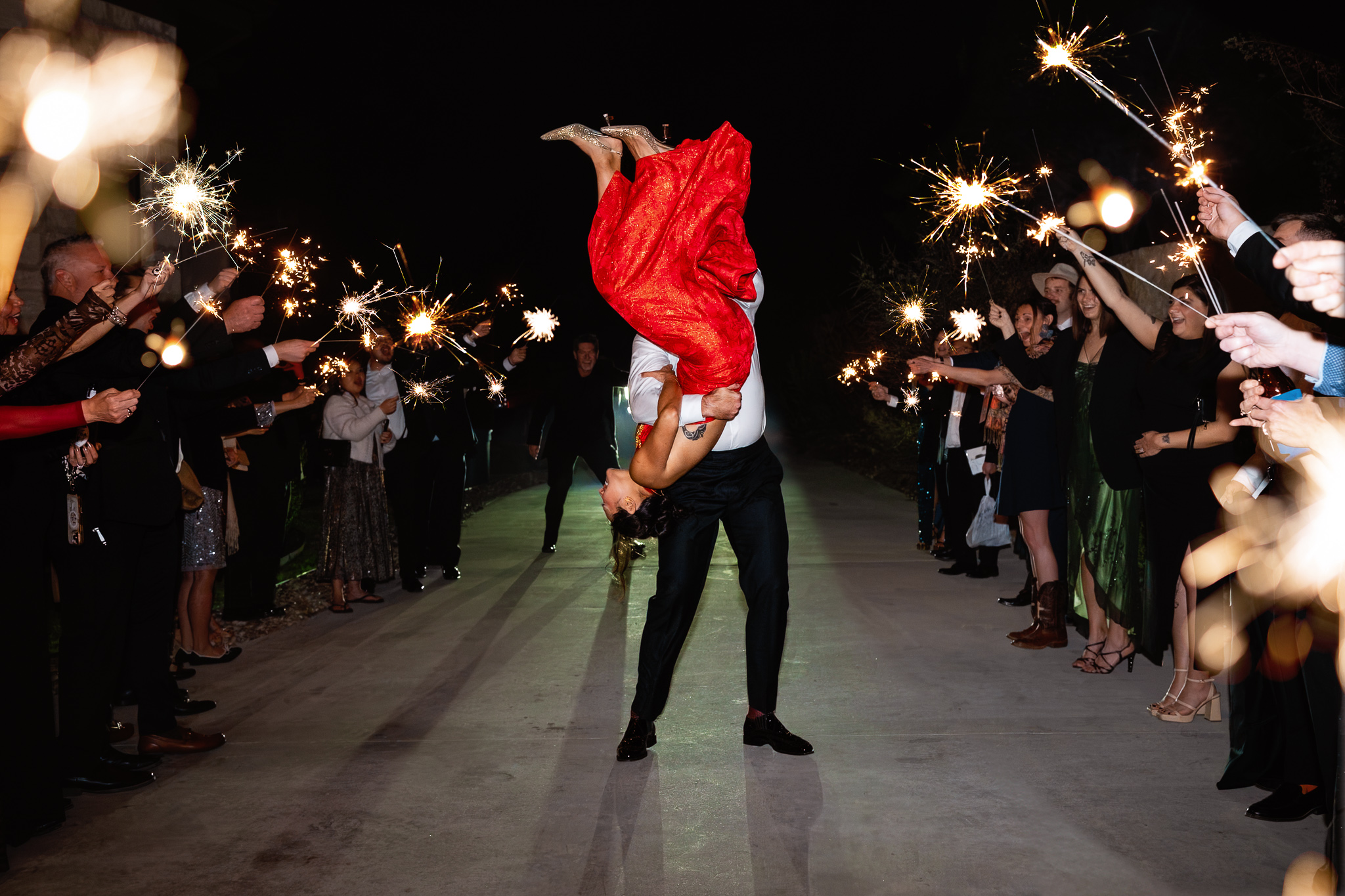 Sharlene and Chip laughing during their sparkler exit at The Preserve at Canyon Lake