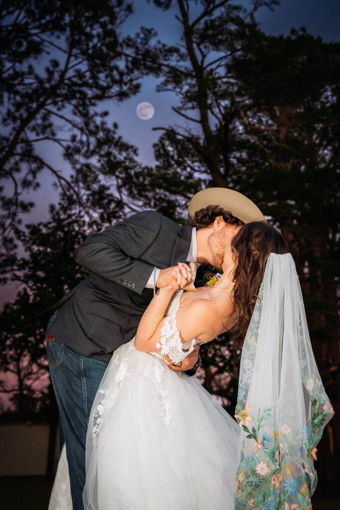 Makenna and Joseph said I do at a real summer camp on a lake in South Texas. Glitter boots, hand embroidered veil, and every single feeling. Photographed by Love, Chelsea Photography.