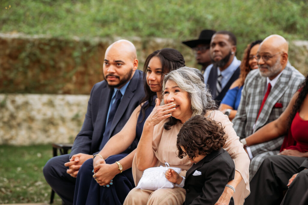 San Antonio wedding photographer captures emotional wedding guest laughing during outdoor ceremony